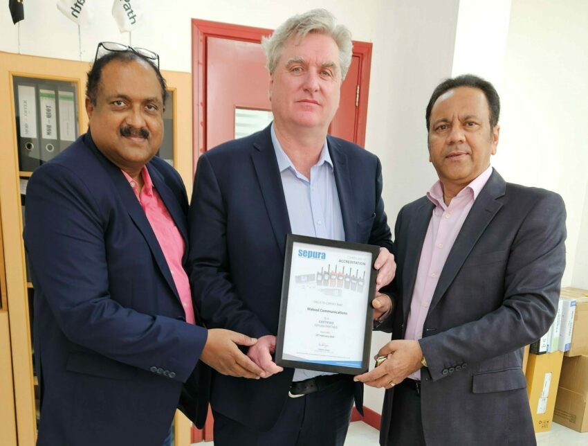 Sepura's Regional Sales Director presenting a Partner Certificate to Waleed Communications' General Manager (right) and Head of Sales (left)